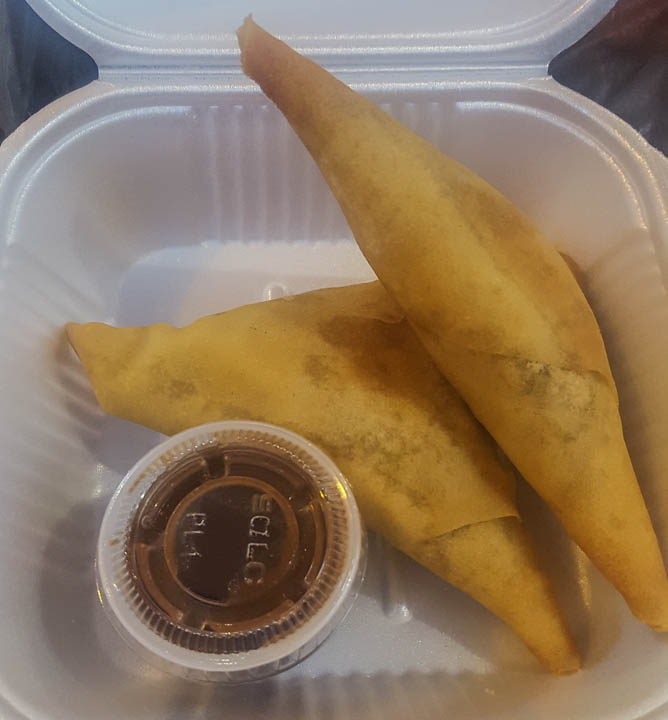Fried samosas with brown sauce from Curry Omm restaurant