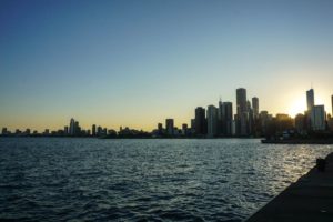 The Chicago skyline against a setting sun from the Navy Pier