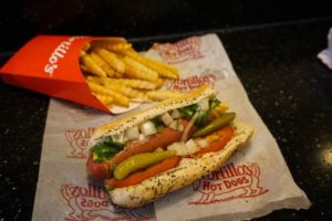 A Chicago hotdog with an order of crinkle cut fries on a Portillo's paper