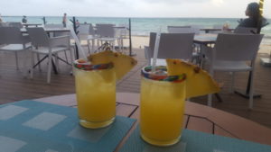 Photo of cocktails with pineapple wedges on the beach