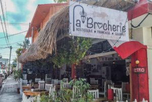 The outside of La Brocherie with the sign in the forefront