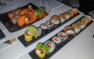 3 plates with an array of sushi on each