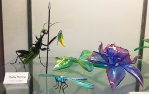 Glass praying mantis, dragonfly and flowers at the Corning Museum of Glass