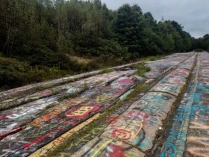 Graffiti highway covered in paint and full of cracks