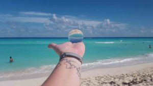 A nice shot with a clear sphere, my world tattoo and the beautiful Playa Delfines beach