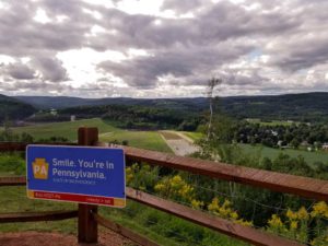 'Smile, you're in Pennsylvania' sign at a lookout on a cloudy day
