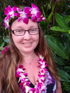 Image of me with a crown and lei made out of purple orchids