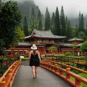 Me walking across the bridge with the Byodo-In Temple in the background