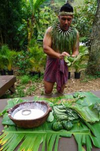 Hawaiian man in traditional dress teaching us how they make lau lau 