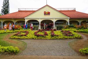The entrance of Dole Plantation with 'Dole' spelled out in planted flowers