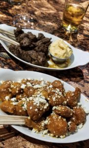 Breaded cauliflower coated in buffalo sauce topped with feta cheese and steak skewers with a side of dip at Black Iron Grill, Miles City Montana