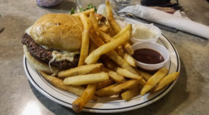 Burger and fries on a white plate with sides of mayo and bbq sauce at Stella's Kitchen and Bakery, Billings, Montana