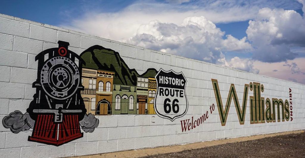 A mural with a train engine, a line of buildings and a 'historic route 66' sign beside the words 'Welcome to Williams, Arizona'